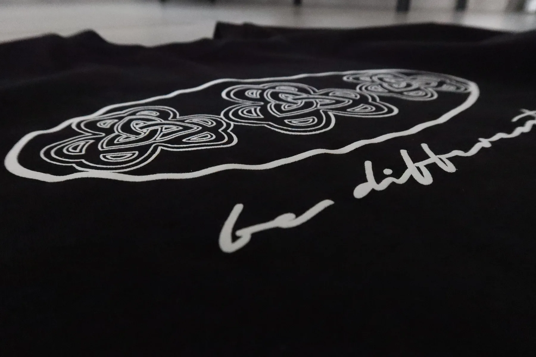 Close-up of the be different print on heavyweight cotton